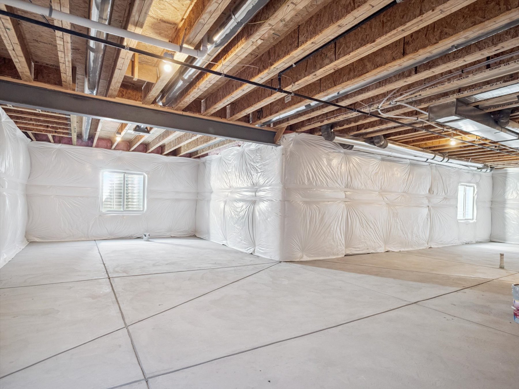 A room with a tile floor and a white wall with a window.