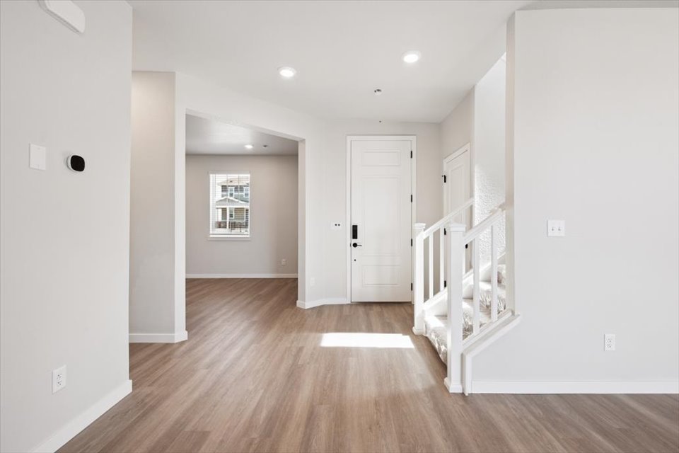A room with white walls and a wood floor.