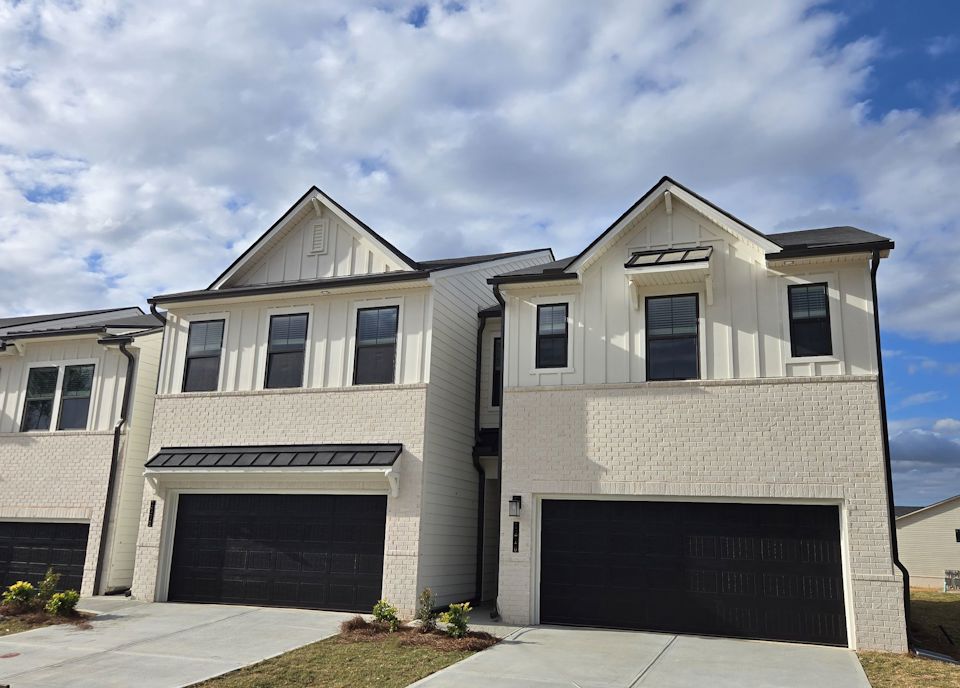 A grey house with a garage.