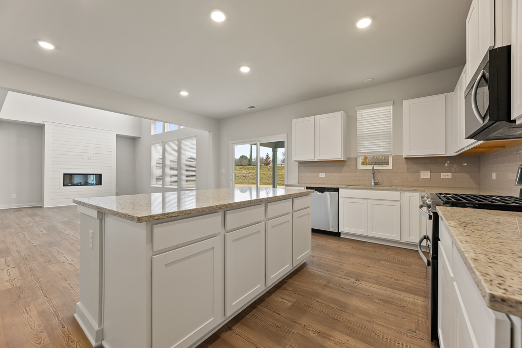 A kitchen with white cabinets.