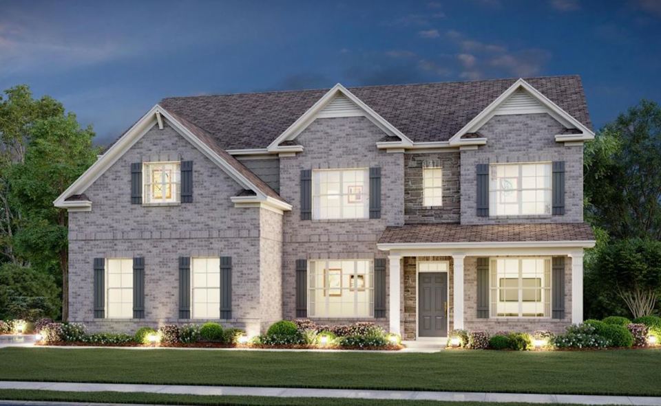 A large house with a lawn in front of it.
