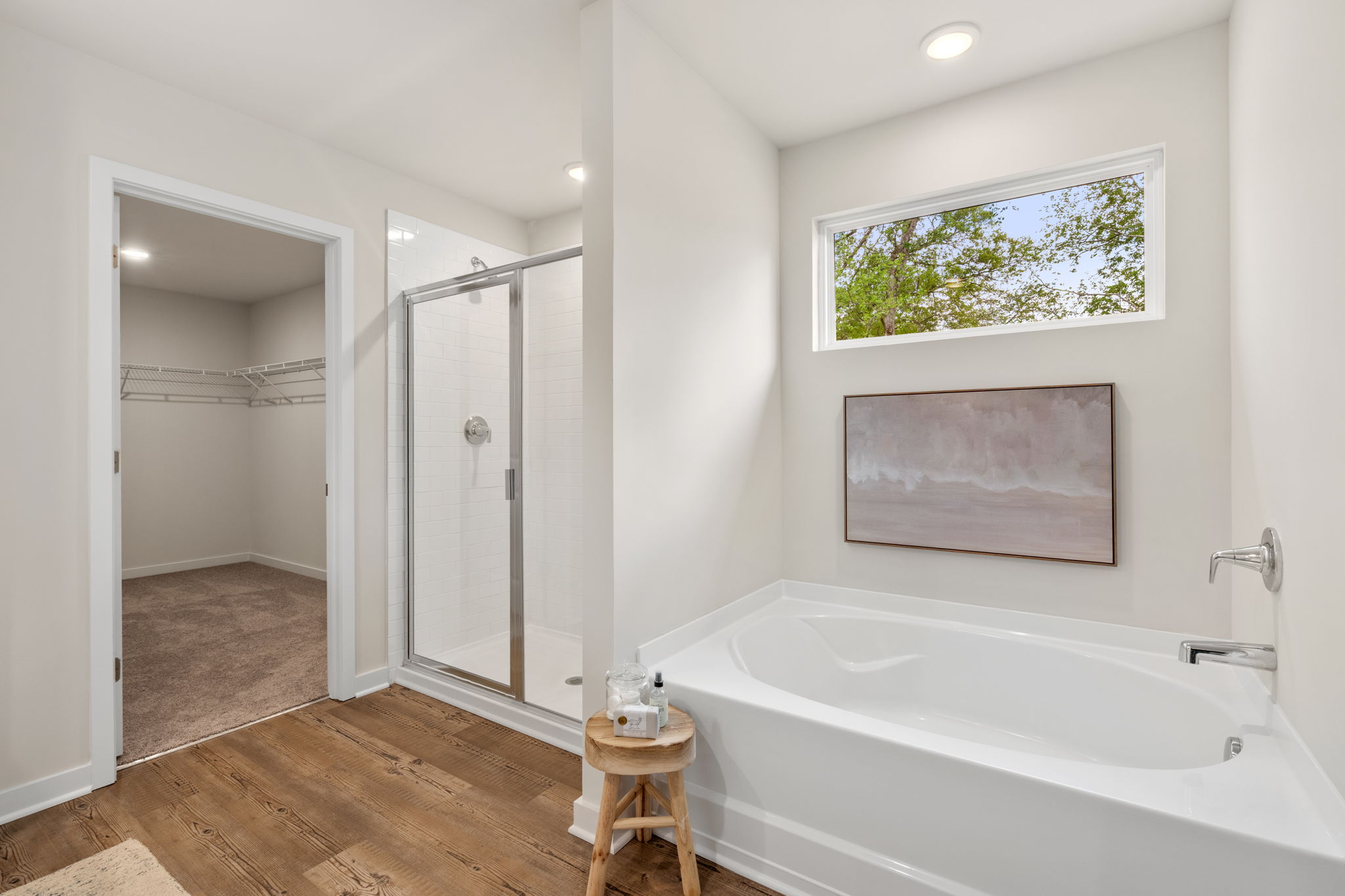 A bathroom with a tub and a shower.