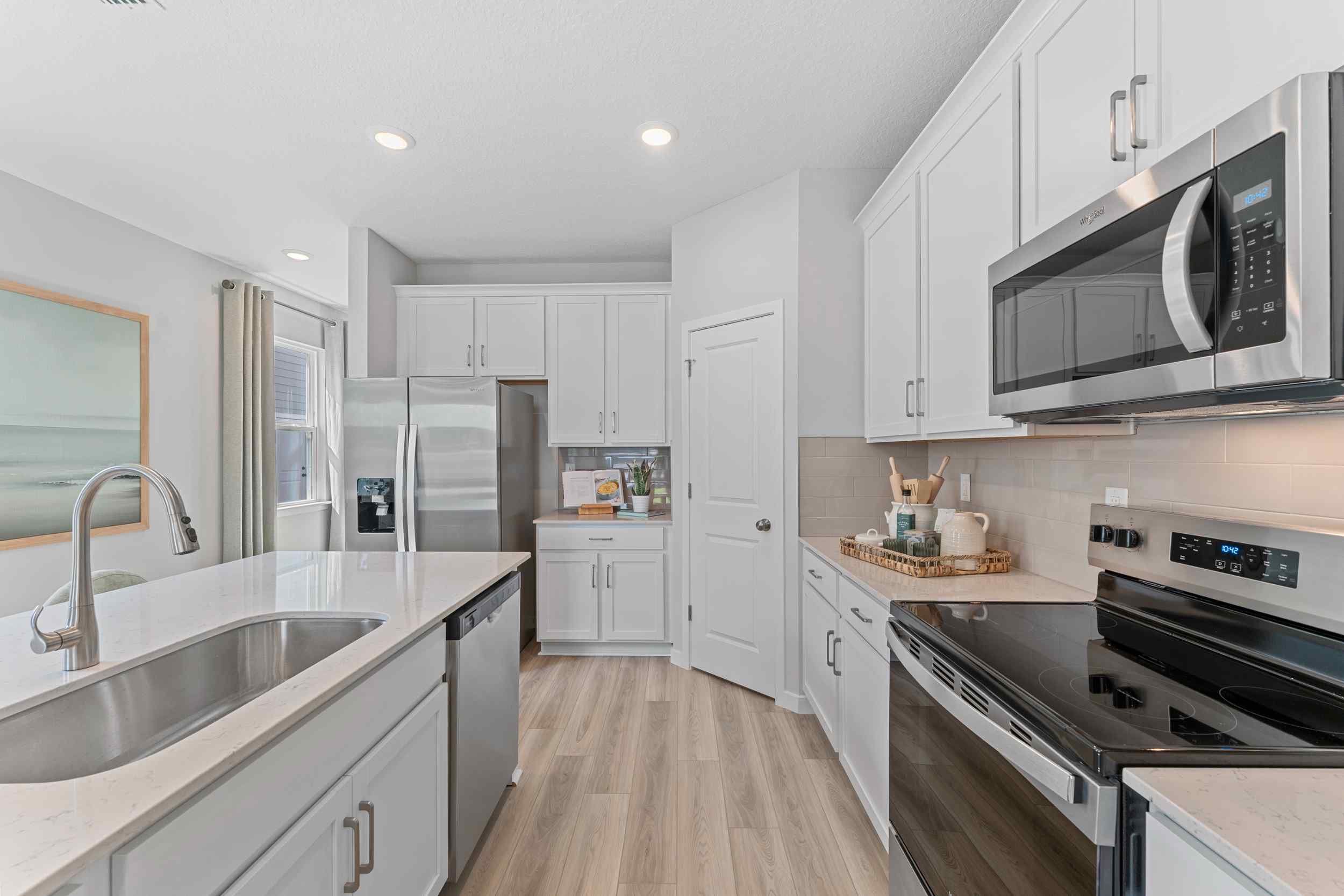 Laurel II Model Home Kitchen with Quartz Counters and Whirlpool Appliances at Camden Woods in Kingsland, GA