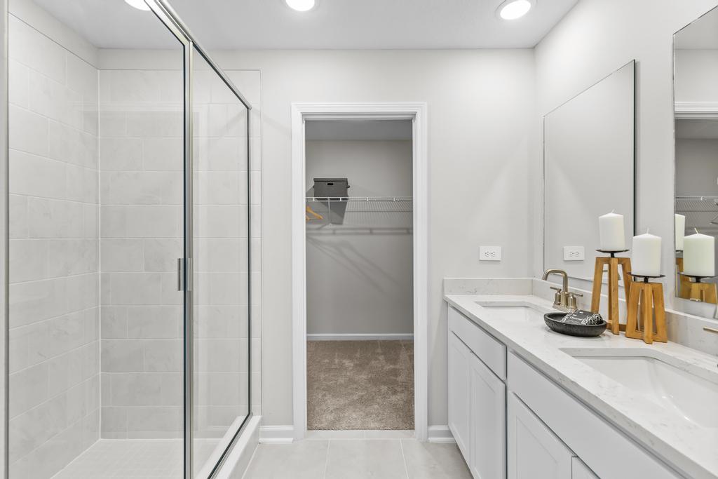 A bathroom with a shower and sink.