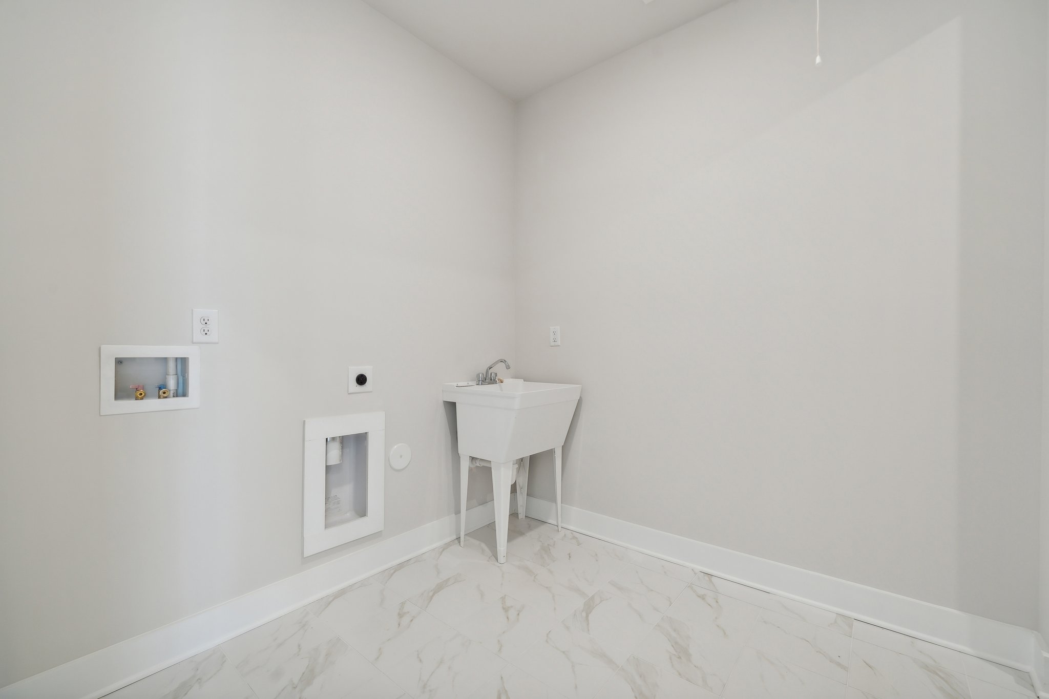 A white bathroom with a sink.