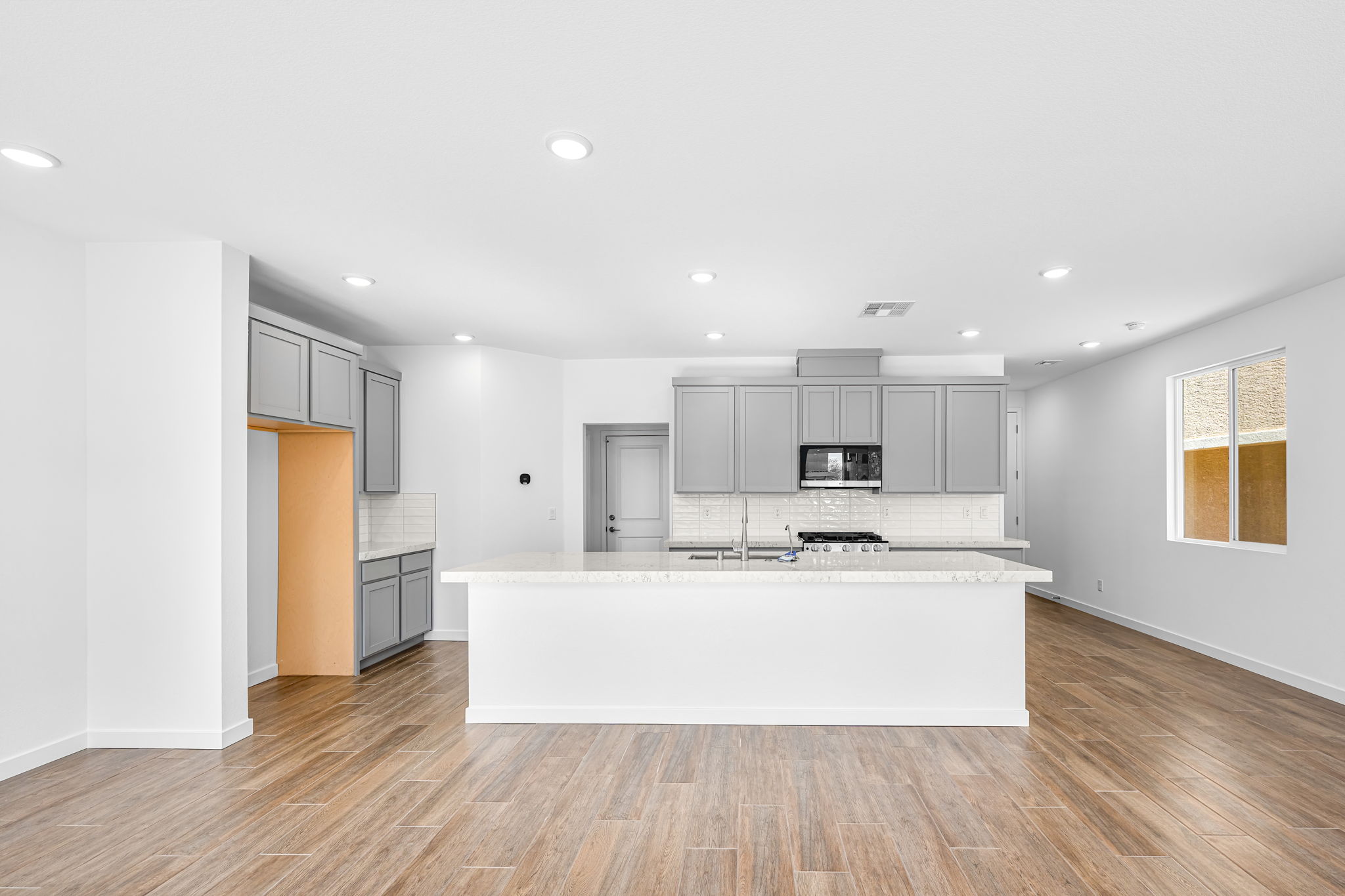A kitchen with white cabinets.