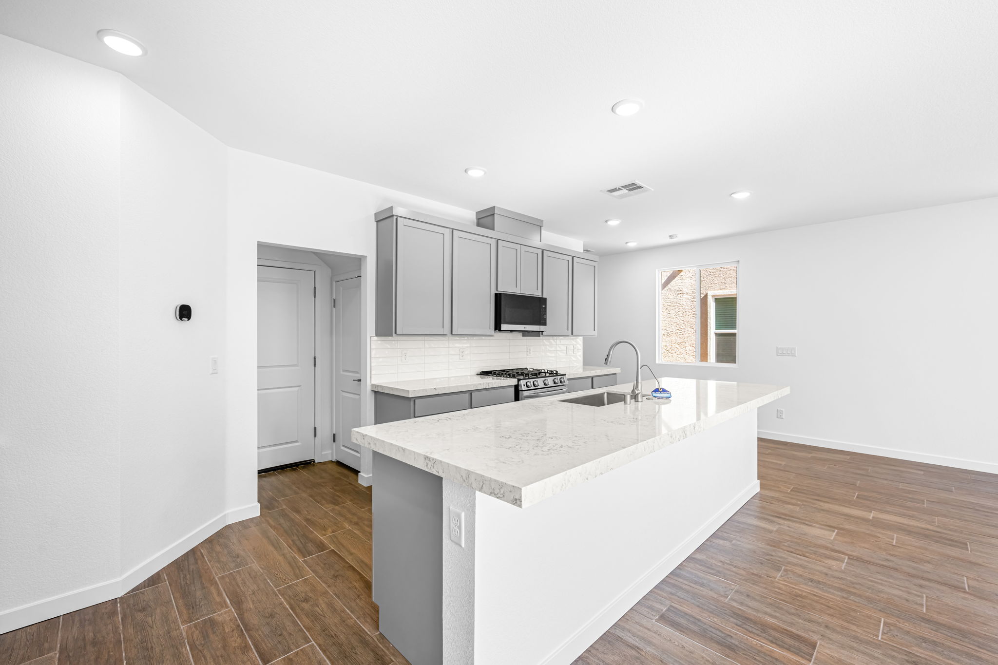 A kitchen with white cabinets.