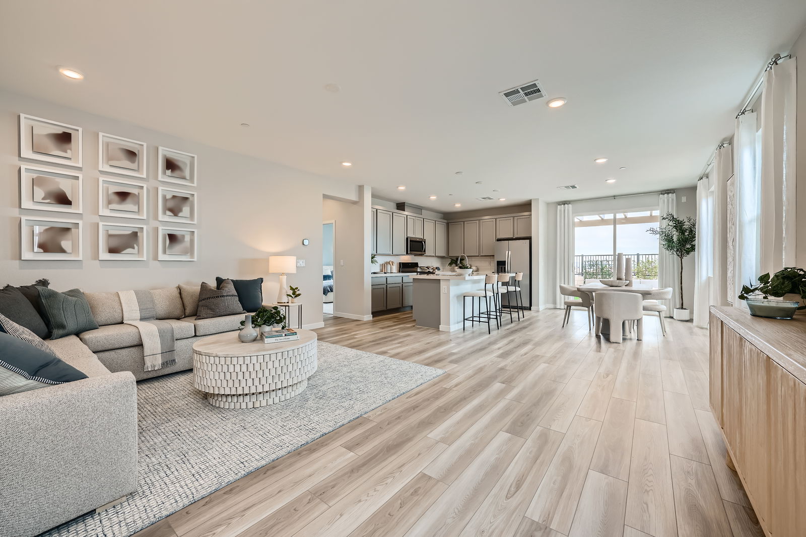 A large living room with a wood floor.