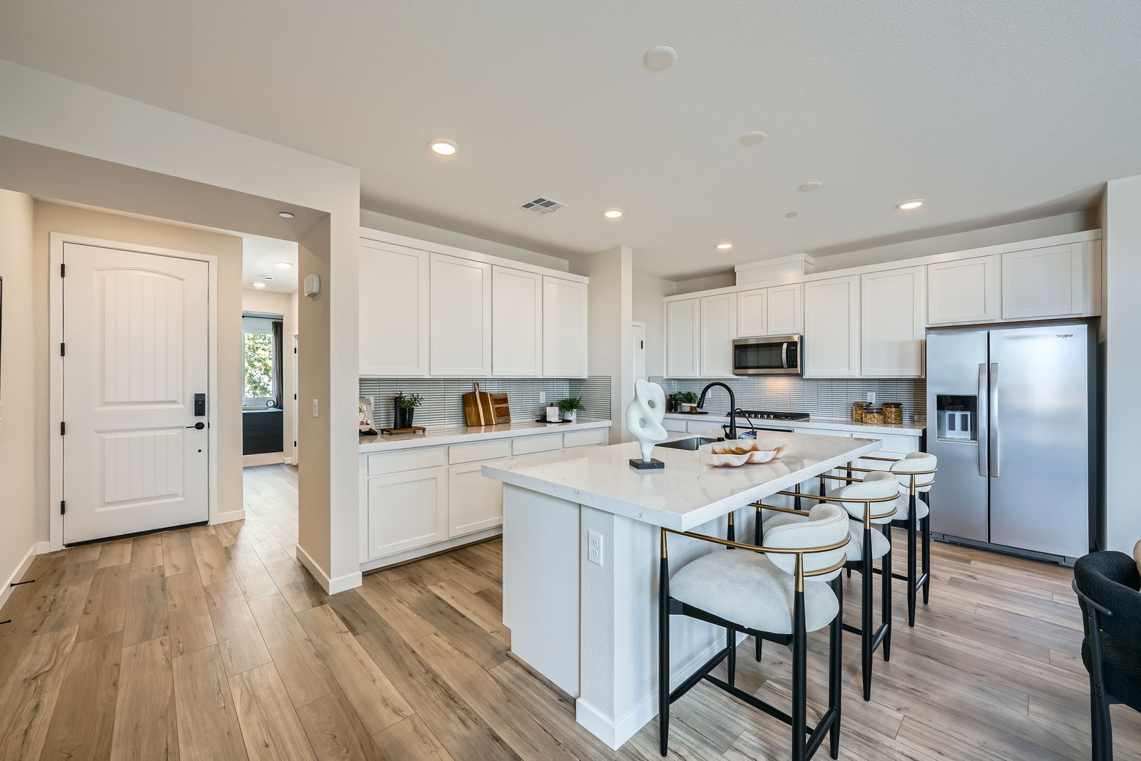 A kitchen with white cabinets.