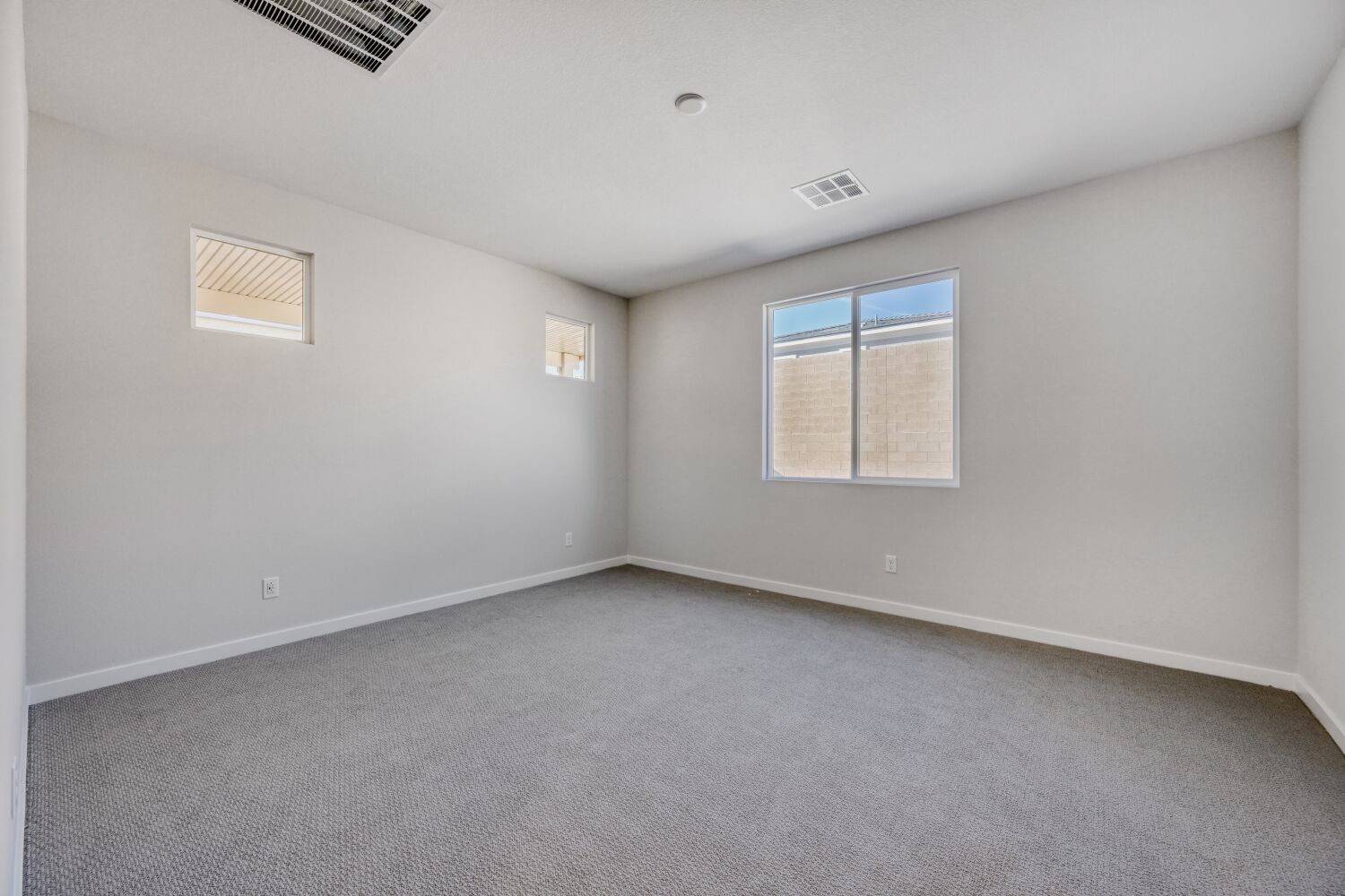 A room with a window and a carpet.