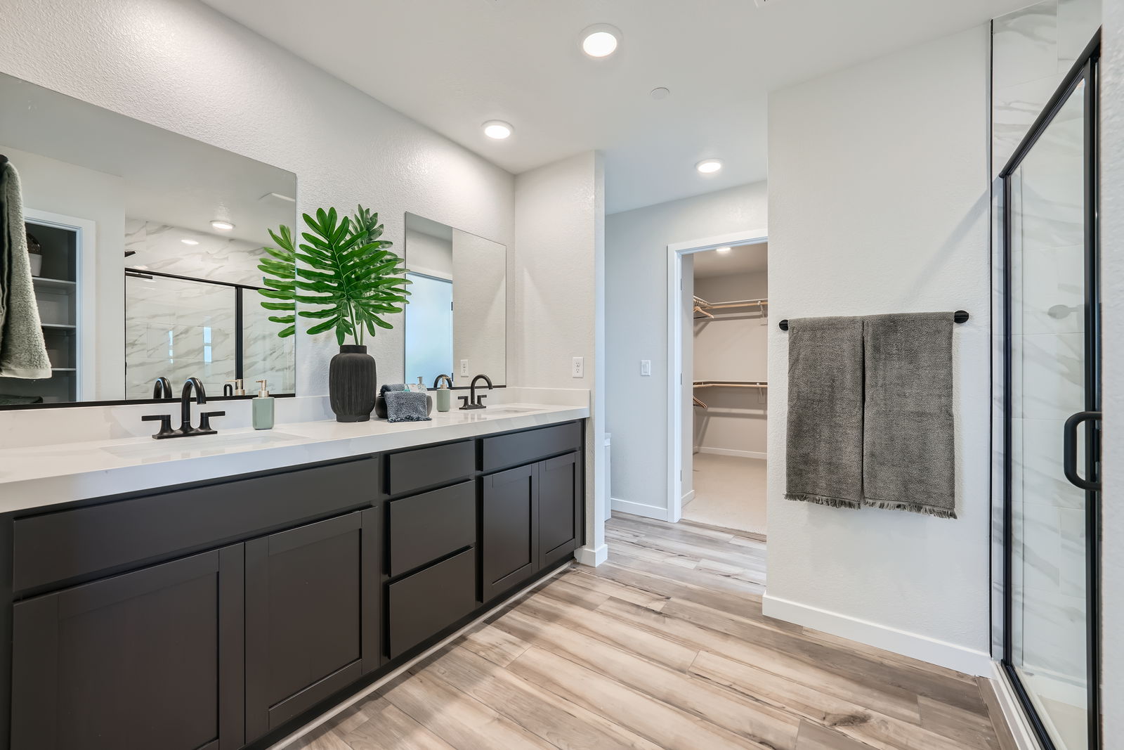 A bathroom with a large mirror.