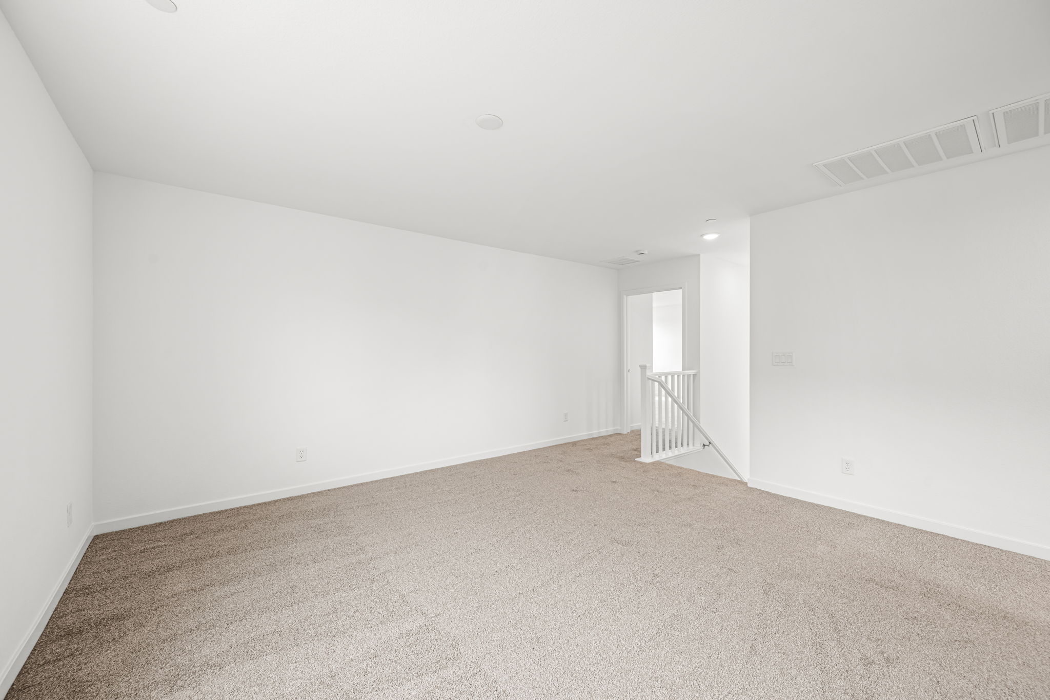 A hallway with white walls.