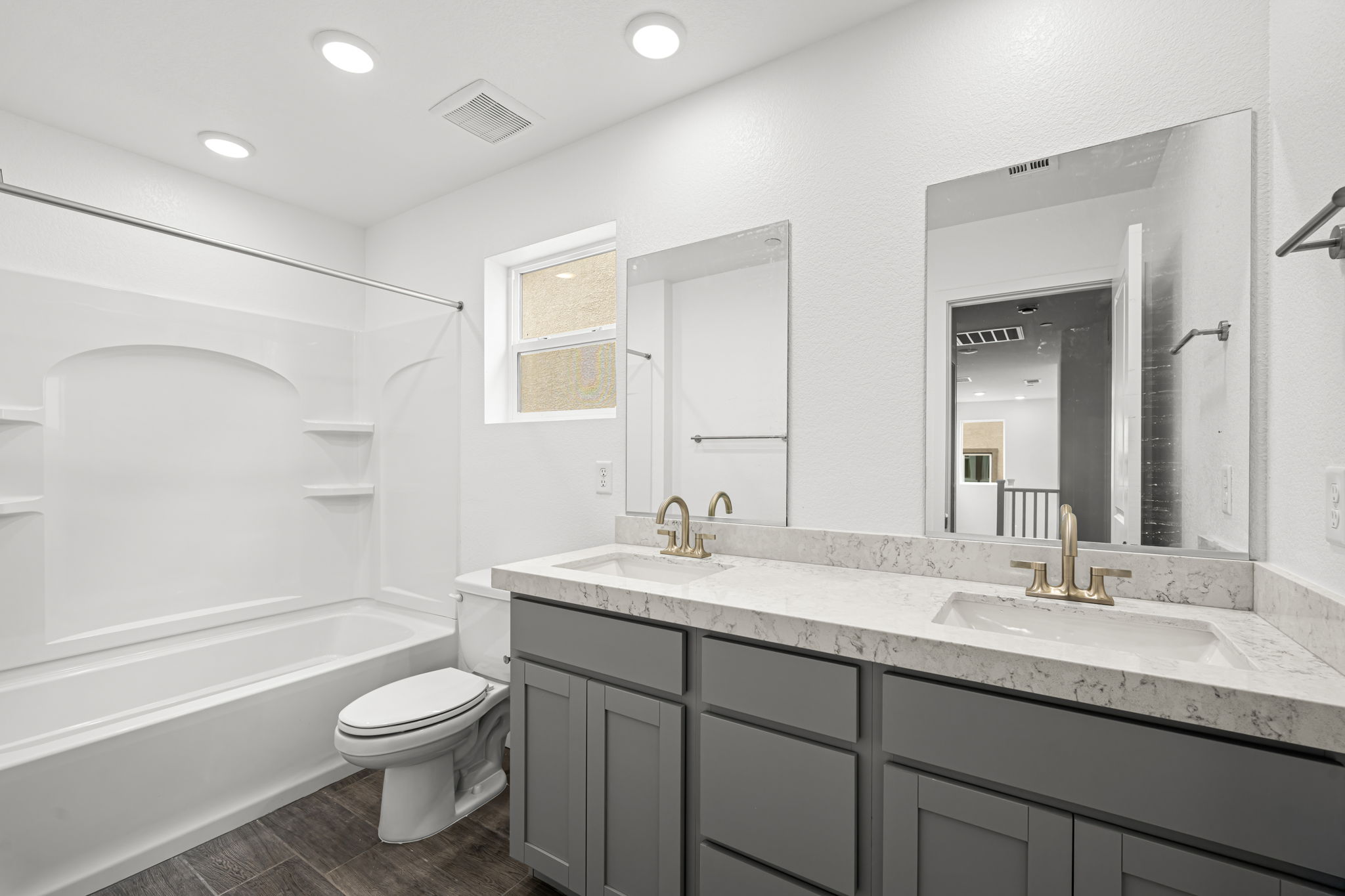 A bathroom with a tub sink and toilet.