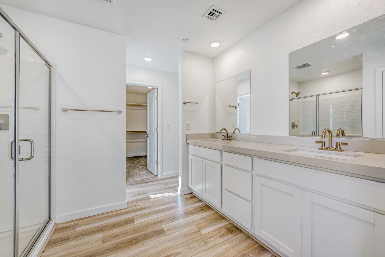 A bathroom with white cabinets.