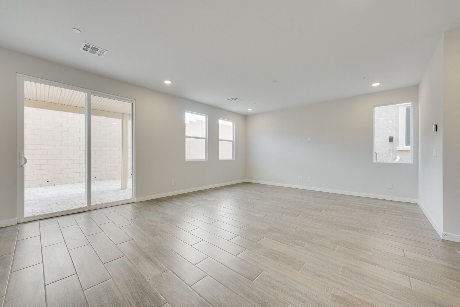 A room with a wood floor and a glass door.