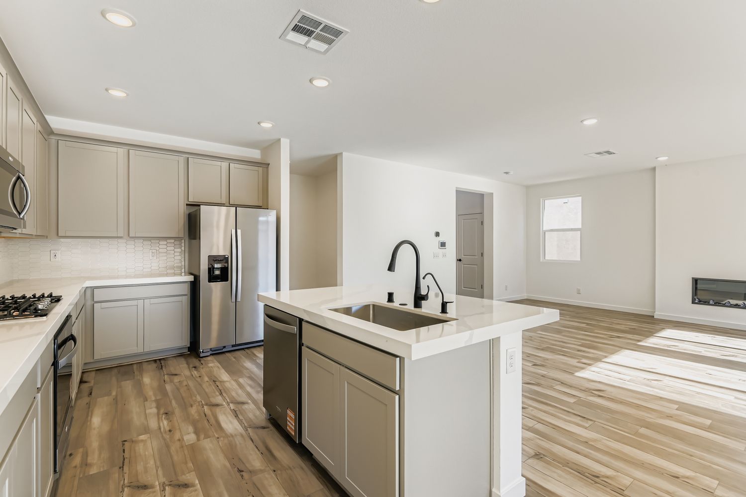A kitchen with white cabinets.