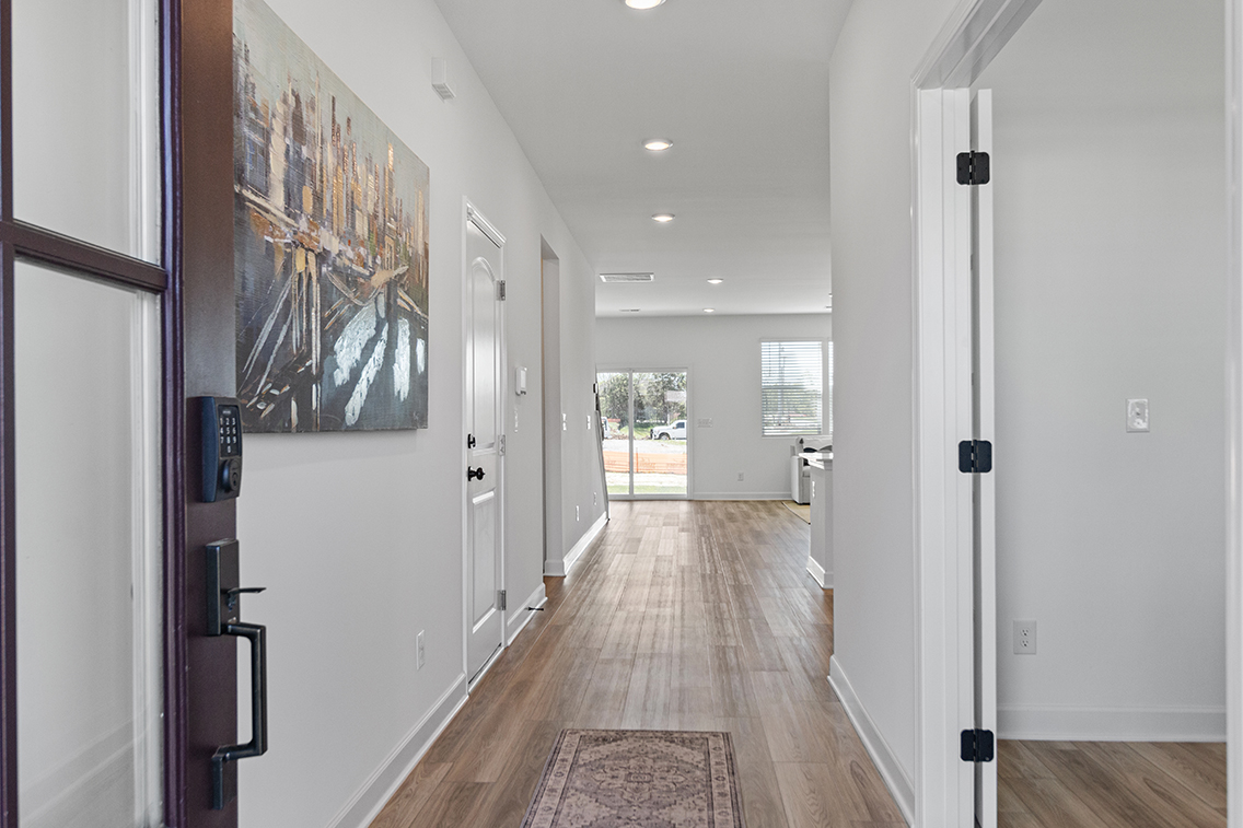 A hallway with white walls.