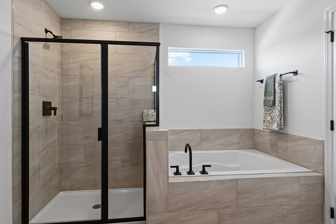 A bathroom with a bathtub and shower.