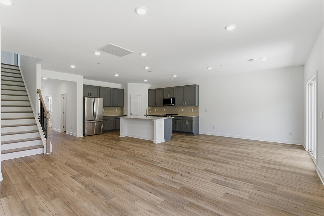 A large kitchen with wood floors.