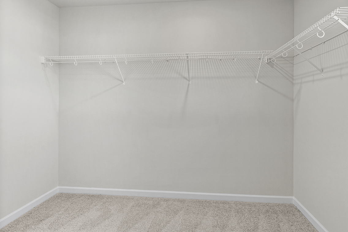 A white wall with a metal railing.