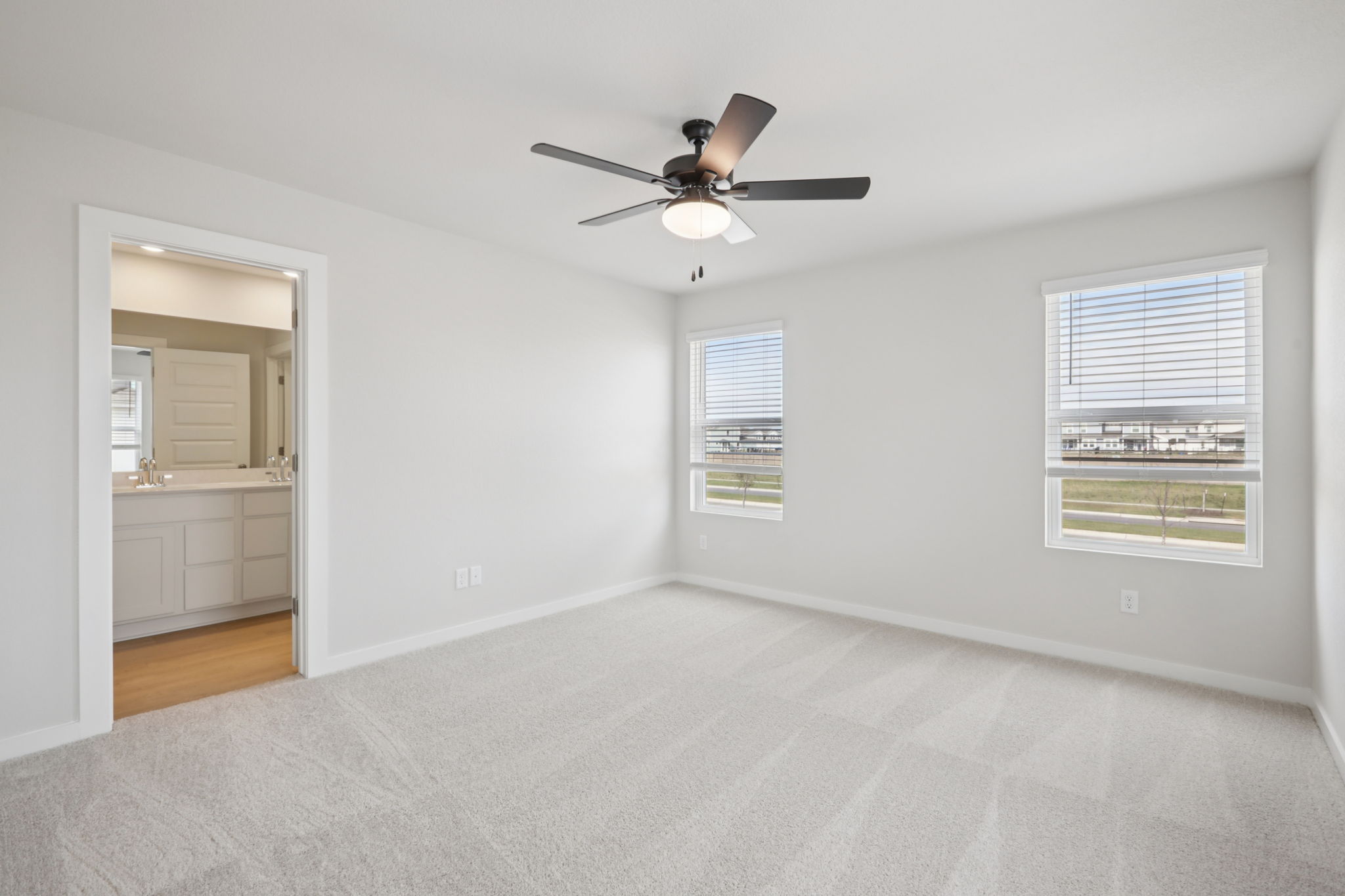 A room with a ceiling fan and a window.
