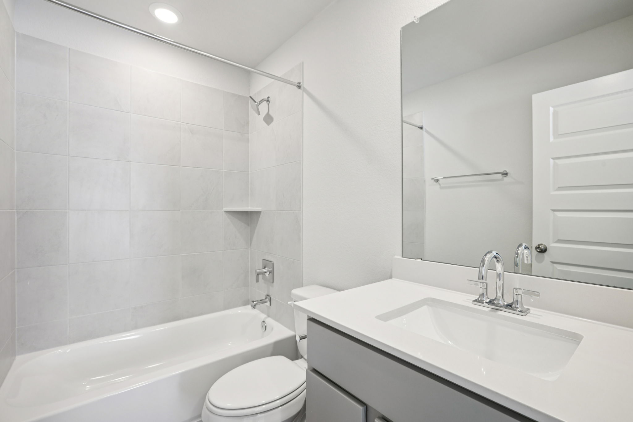 A bathroom with a tub sink and toilet.