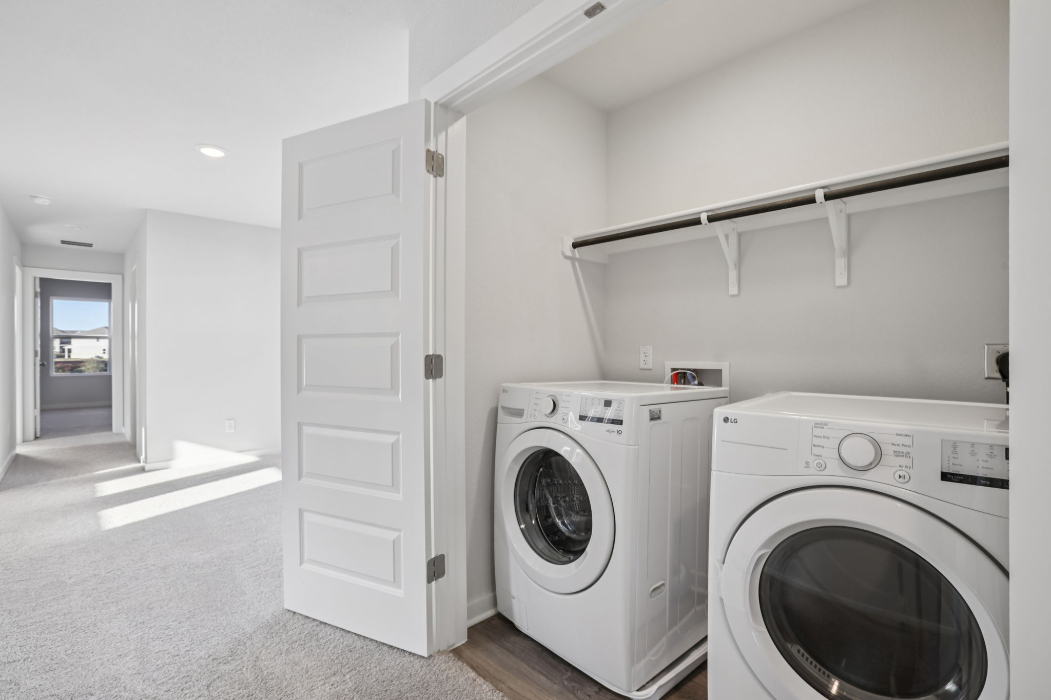 A room with a washer and dryer.
