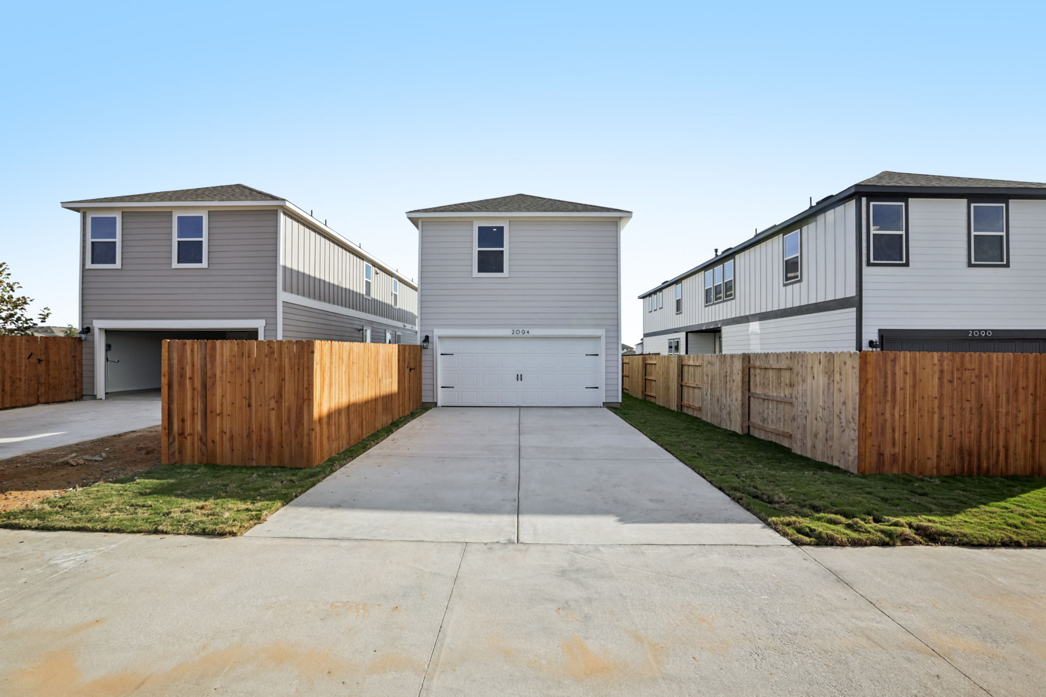 A driveway leading to a house.