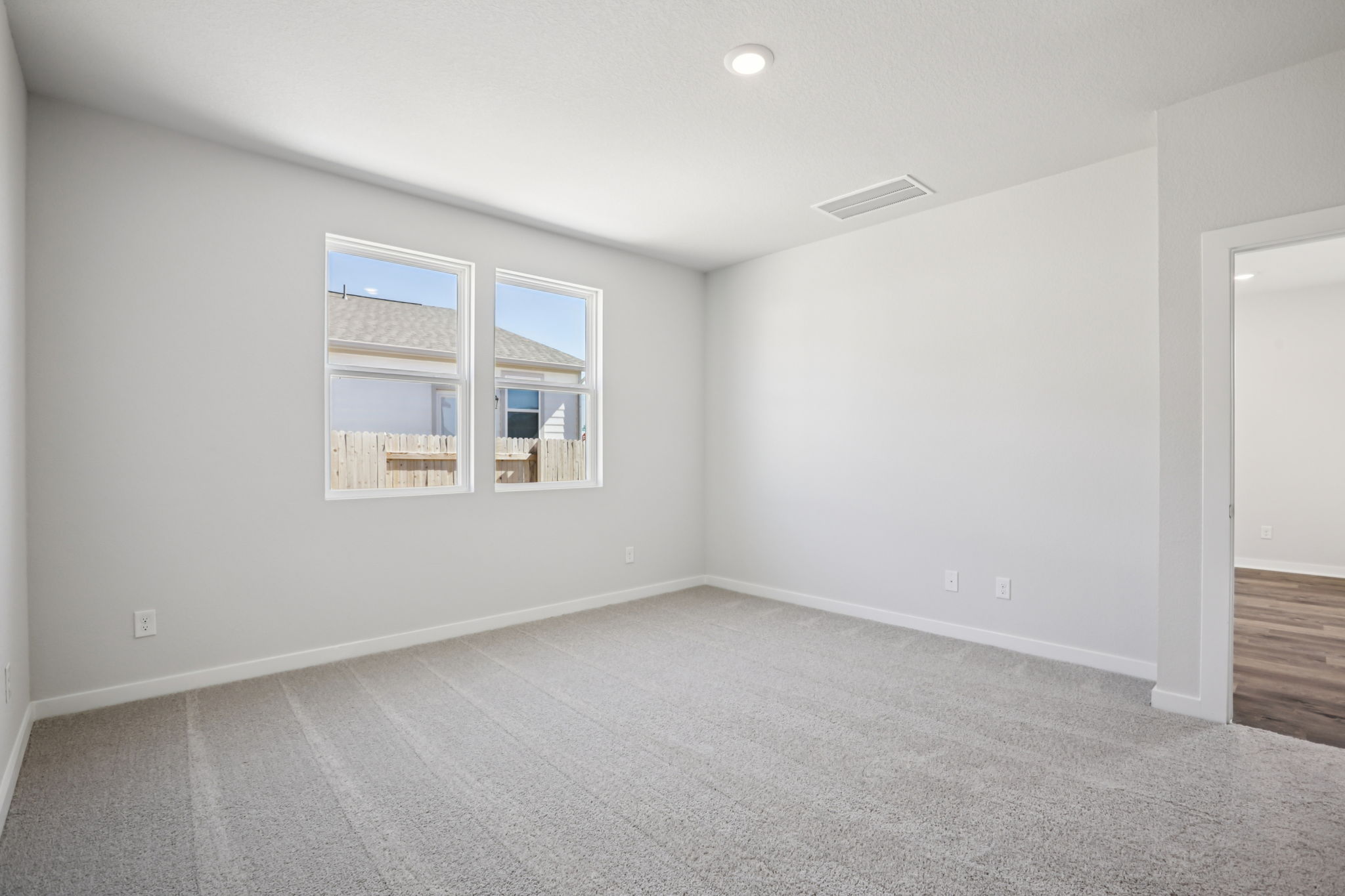 A room with a window and a door.