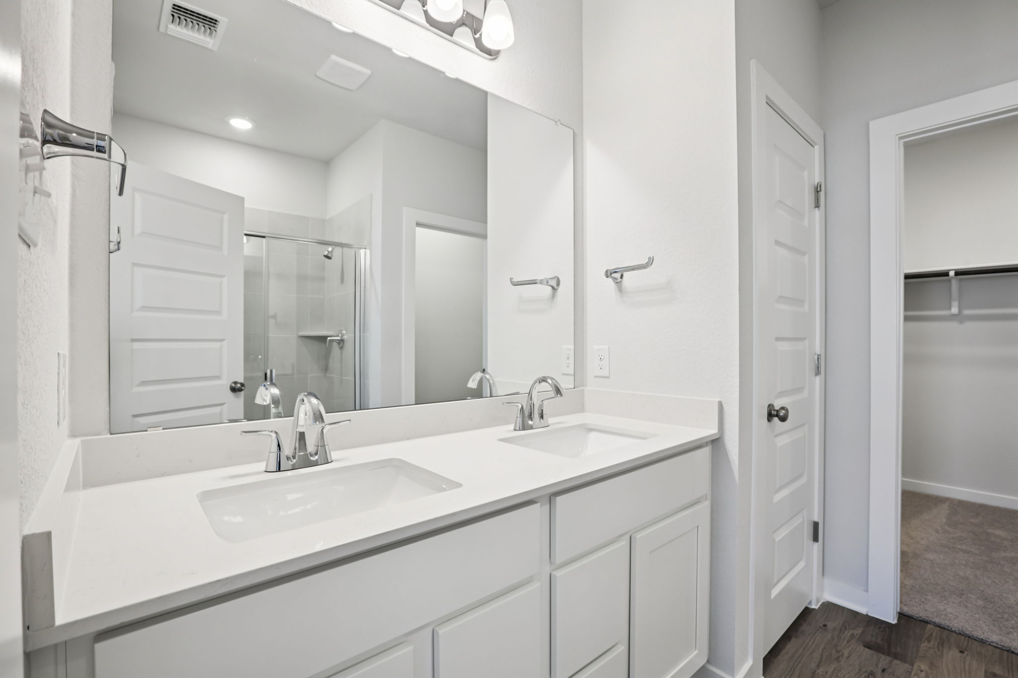 A bathroom with a large mirror.