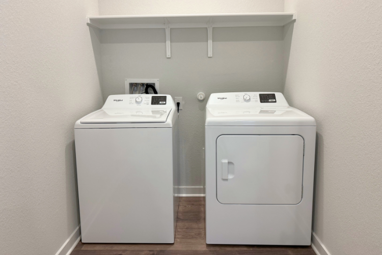 A white machine with a white shelf.