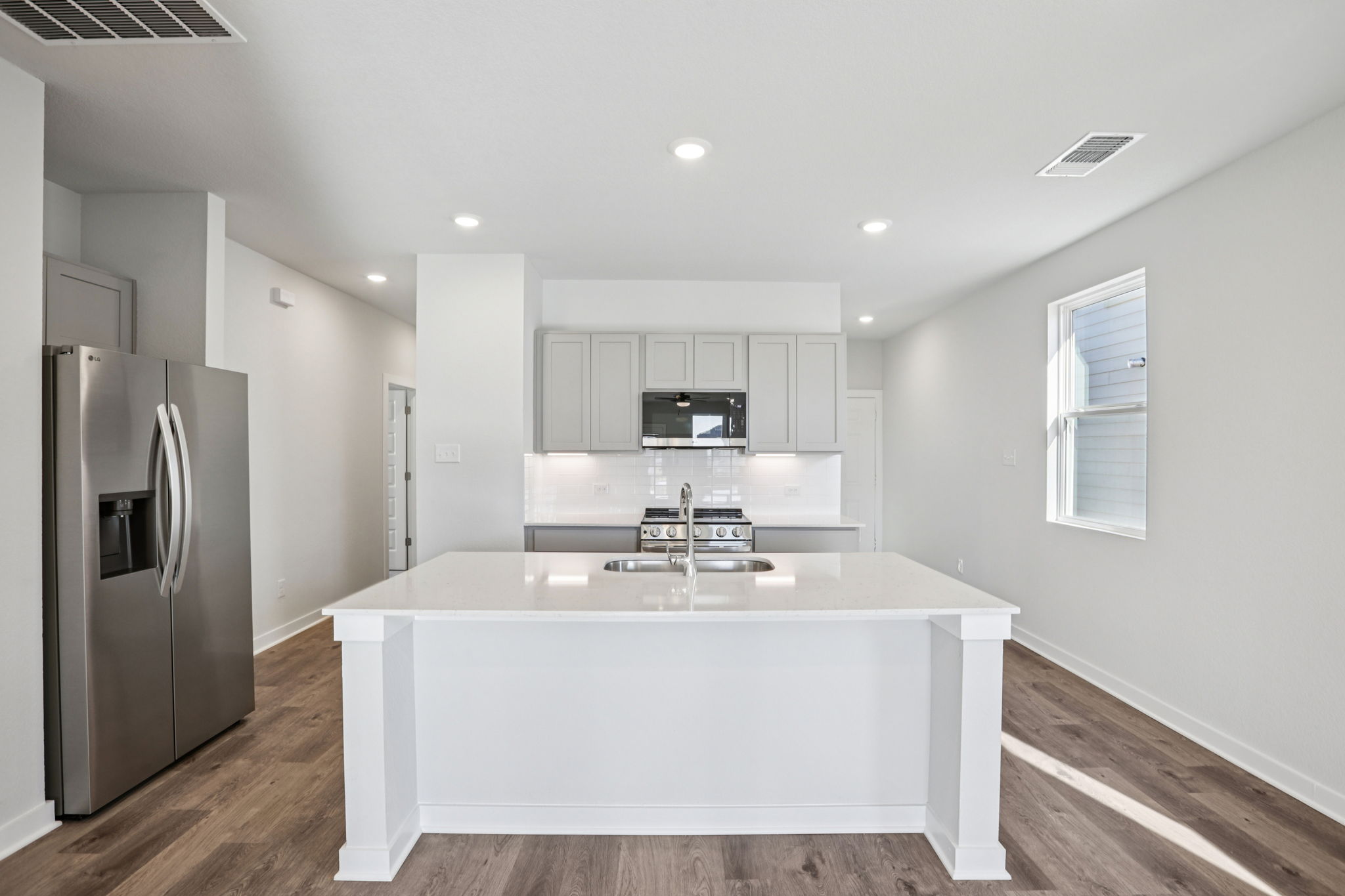 A kitchen with white cabinets.