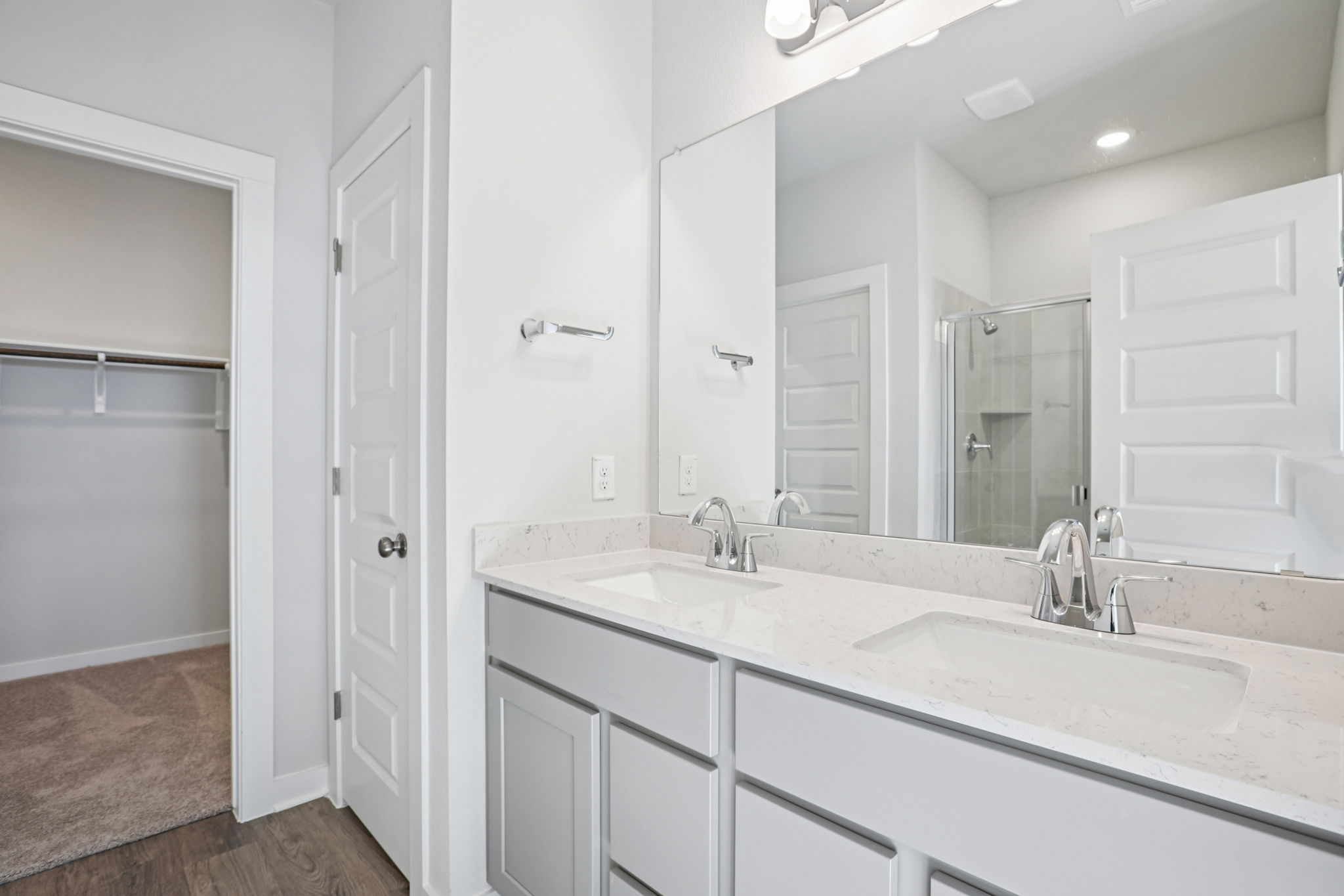 A bathroom with a large mirror.
