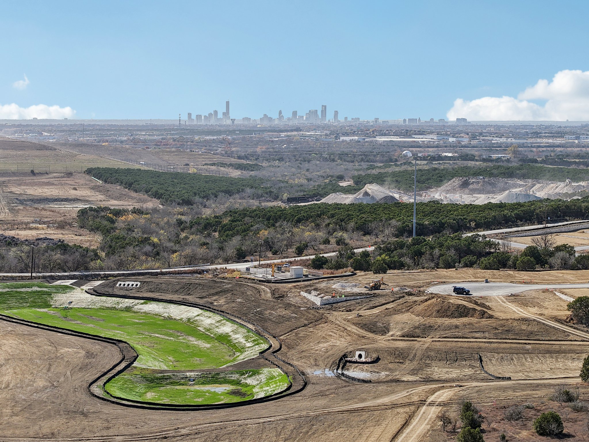 A landscape with a road and trees.