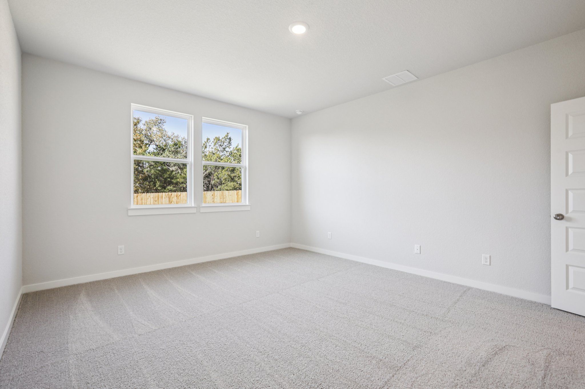 A room with a window and a door.