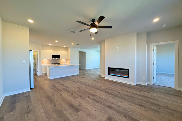 A large living room with a wood floor and a wood floor.