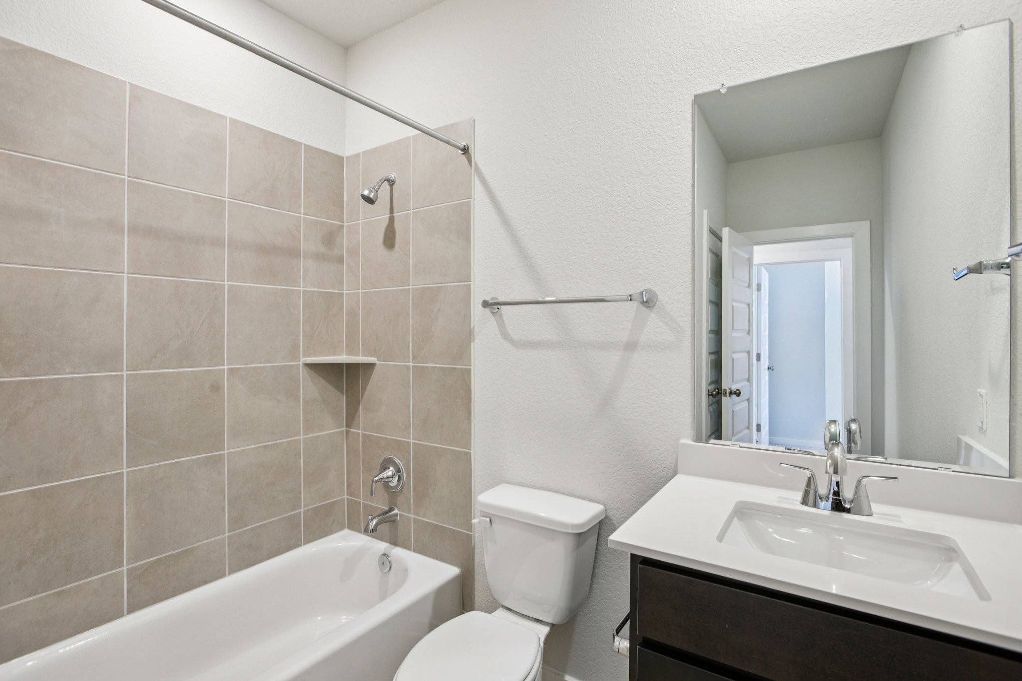 A bathroom with a tub sink and toilet.
