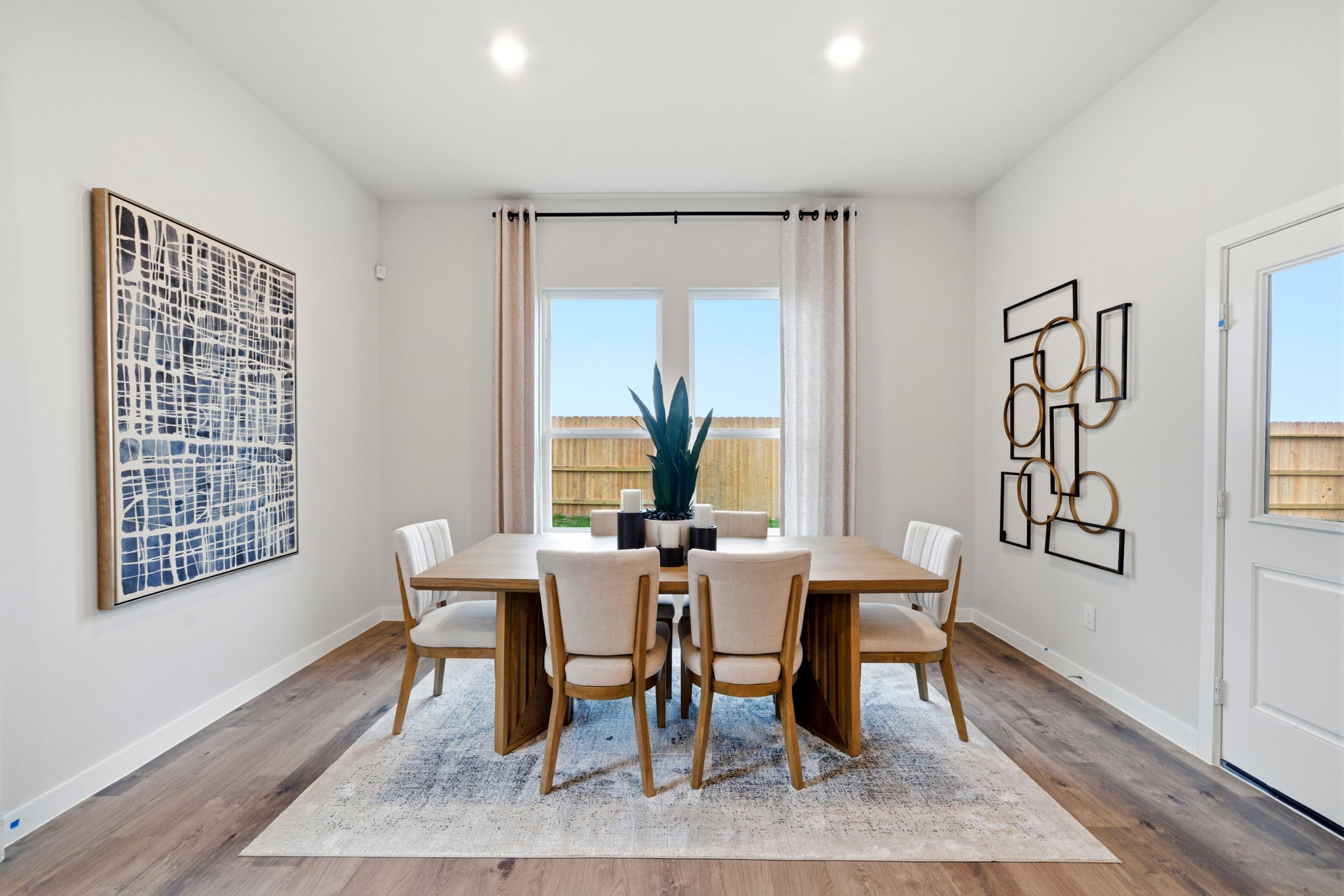 A dining room with a table and chairs.