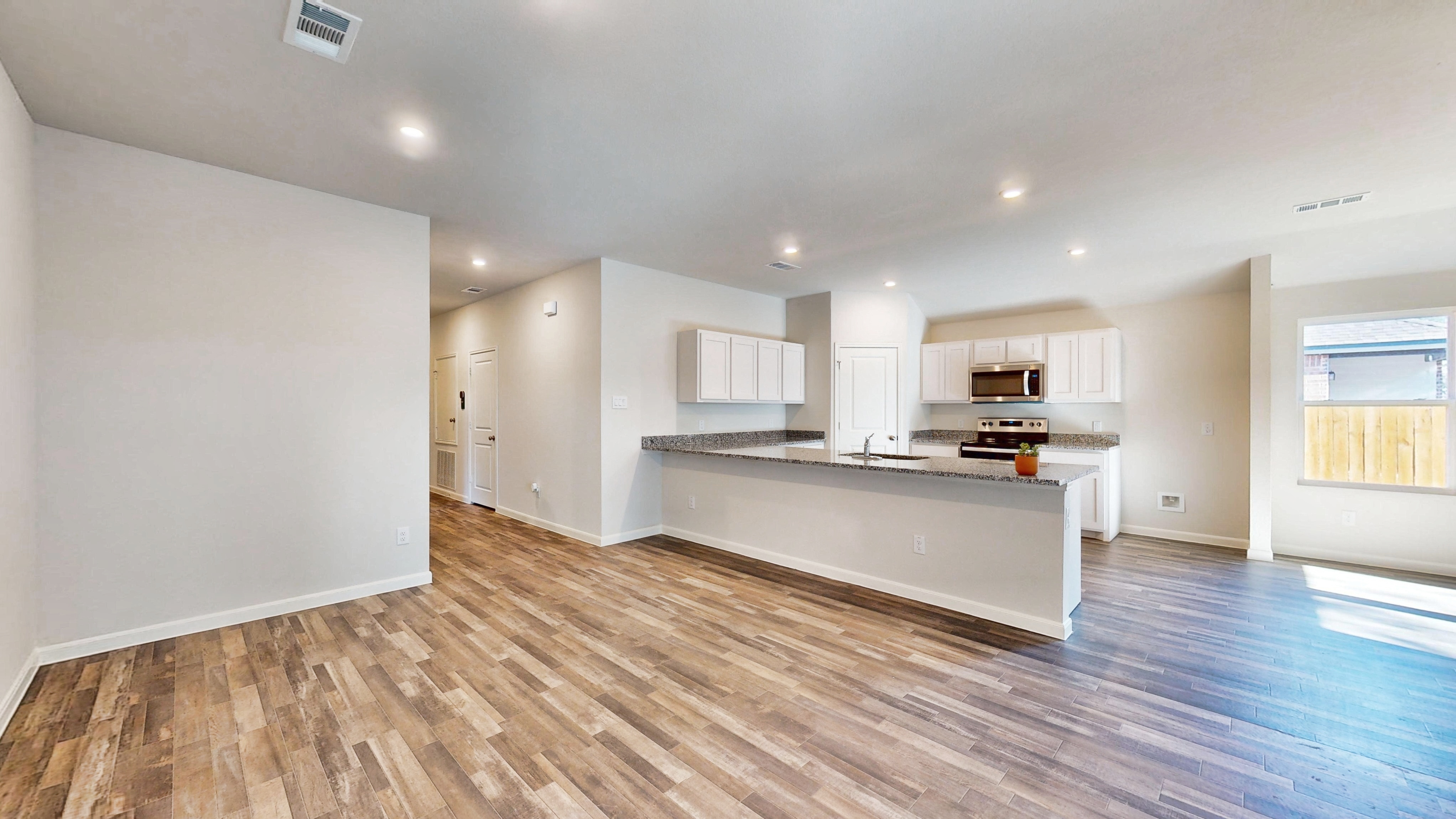 A kitchen with white cabinets.