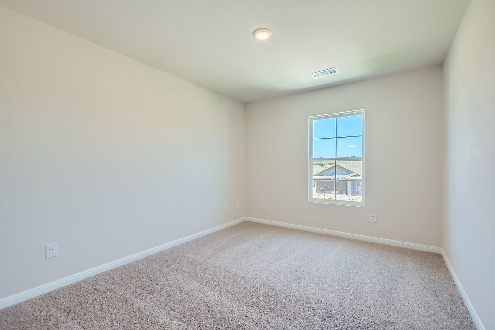 A room with a window and carpet.