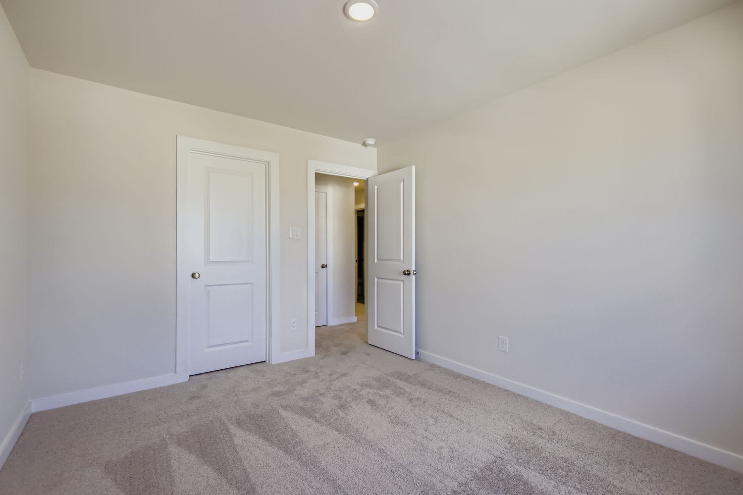 A hallway with white doors.