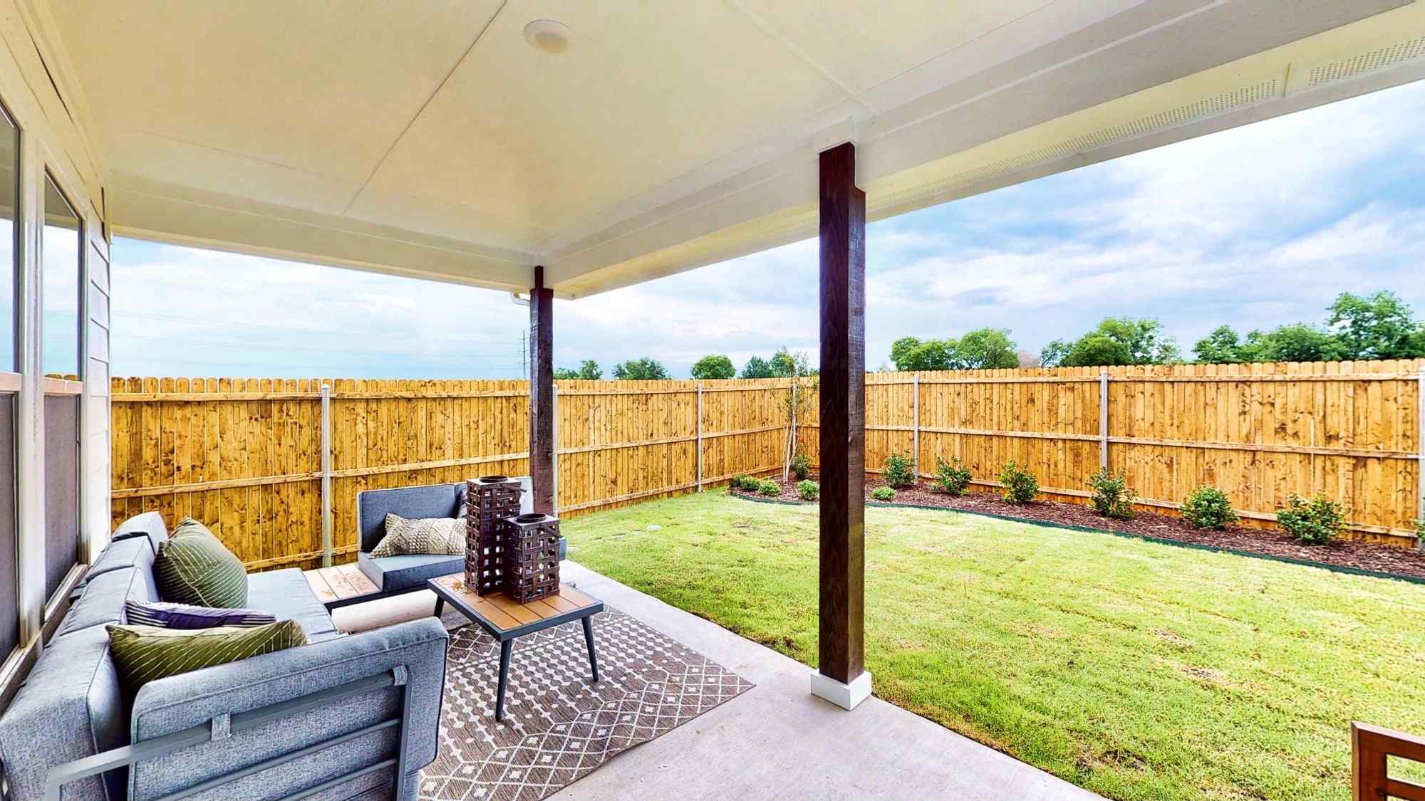 A patio with a table and chairs.