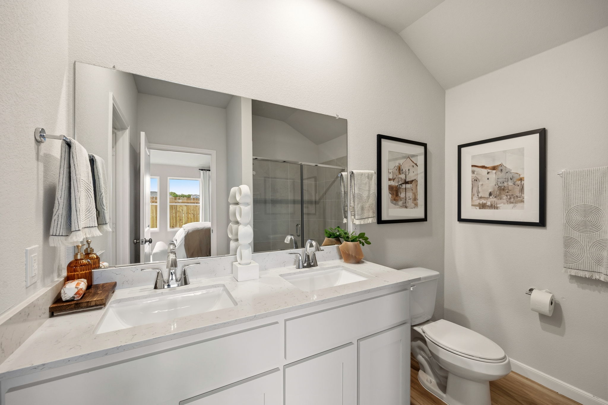 A bathroom with a large mirror.