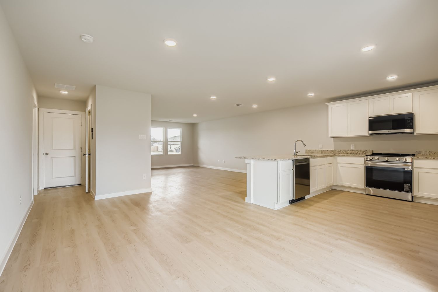 A large kitchen with white cabinets.