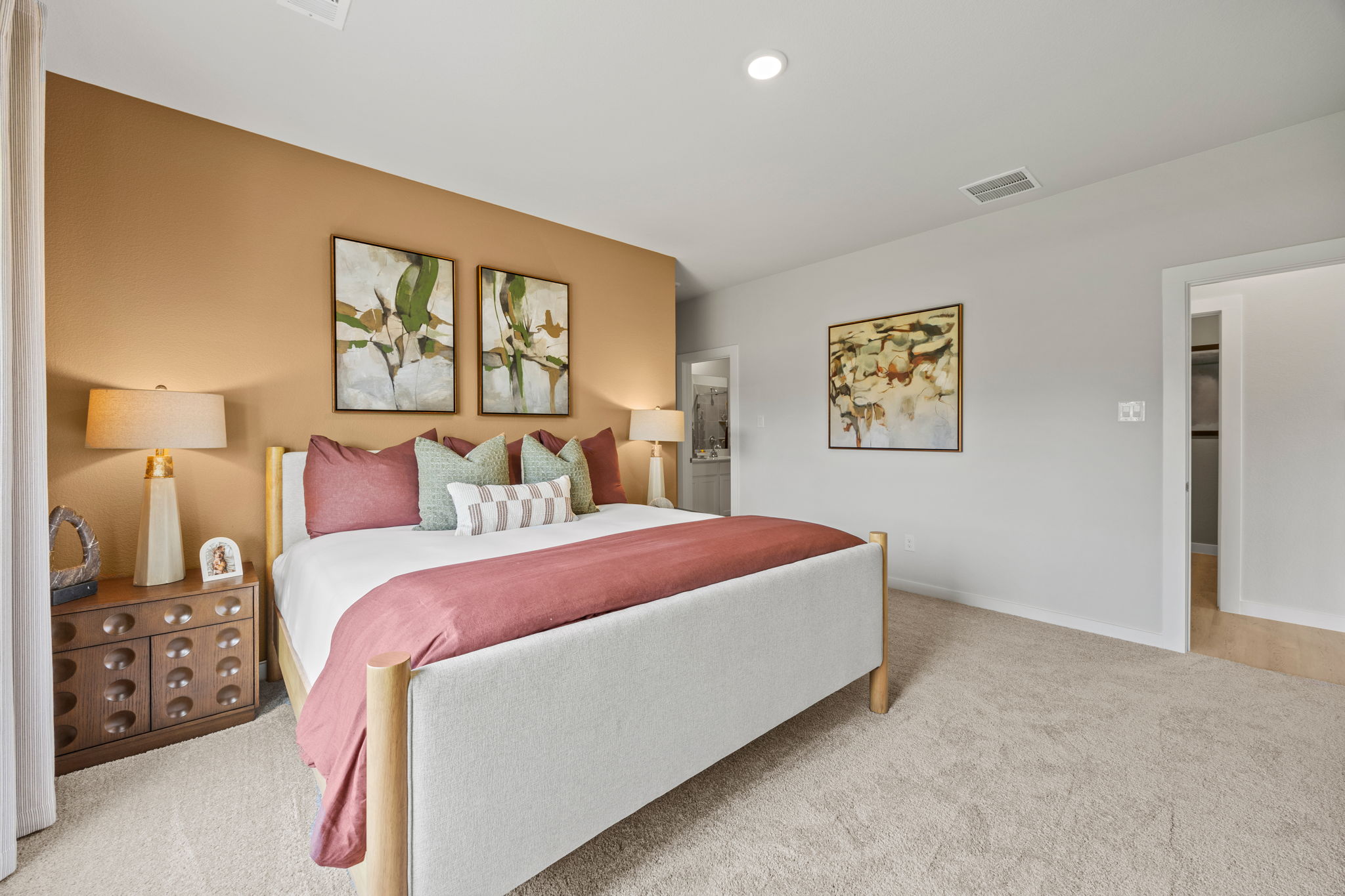 A bedroom with a bed and lamps.