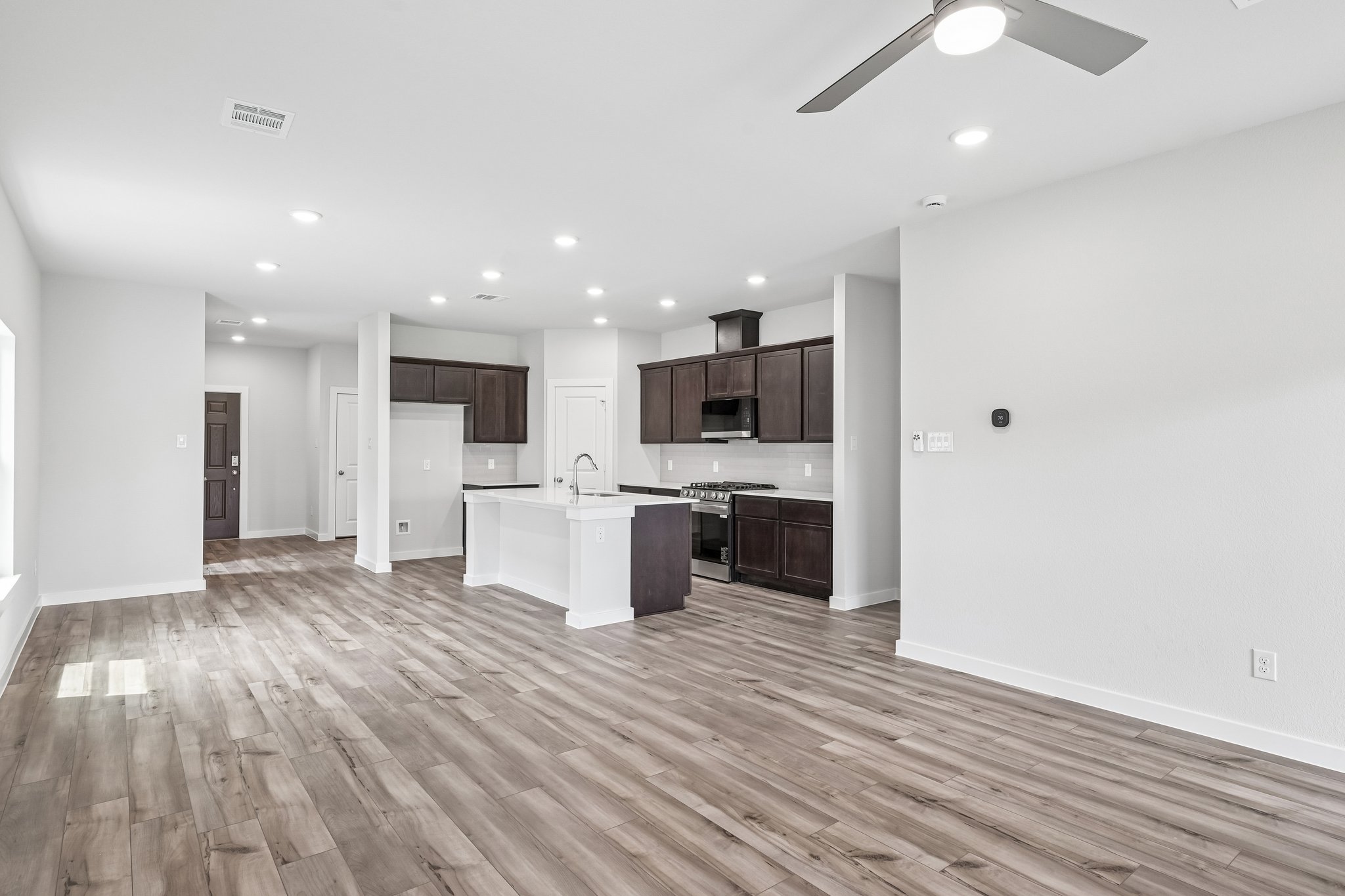A large kitchen with wood floors.