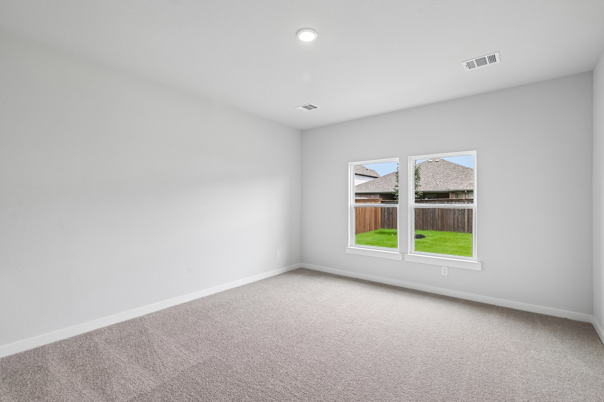 A room with a window and a carpet.