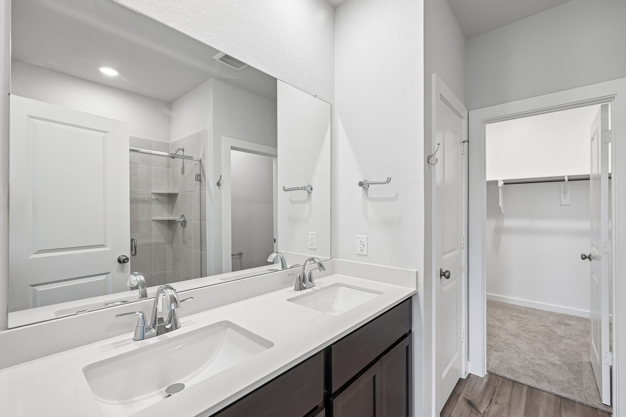 A bathroom with a large mirror.