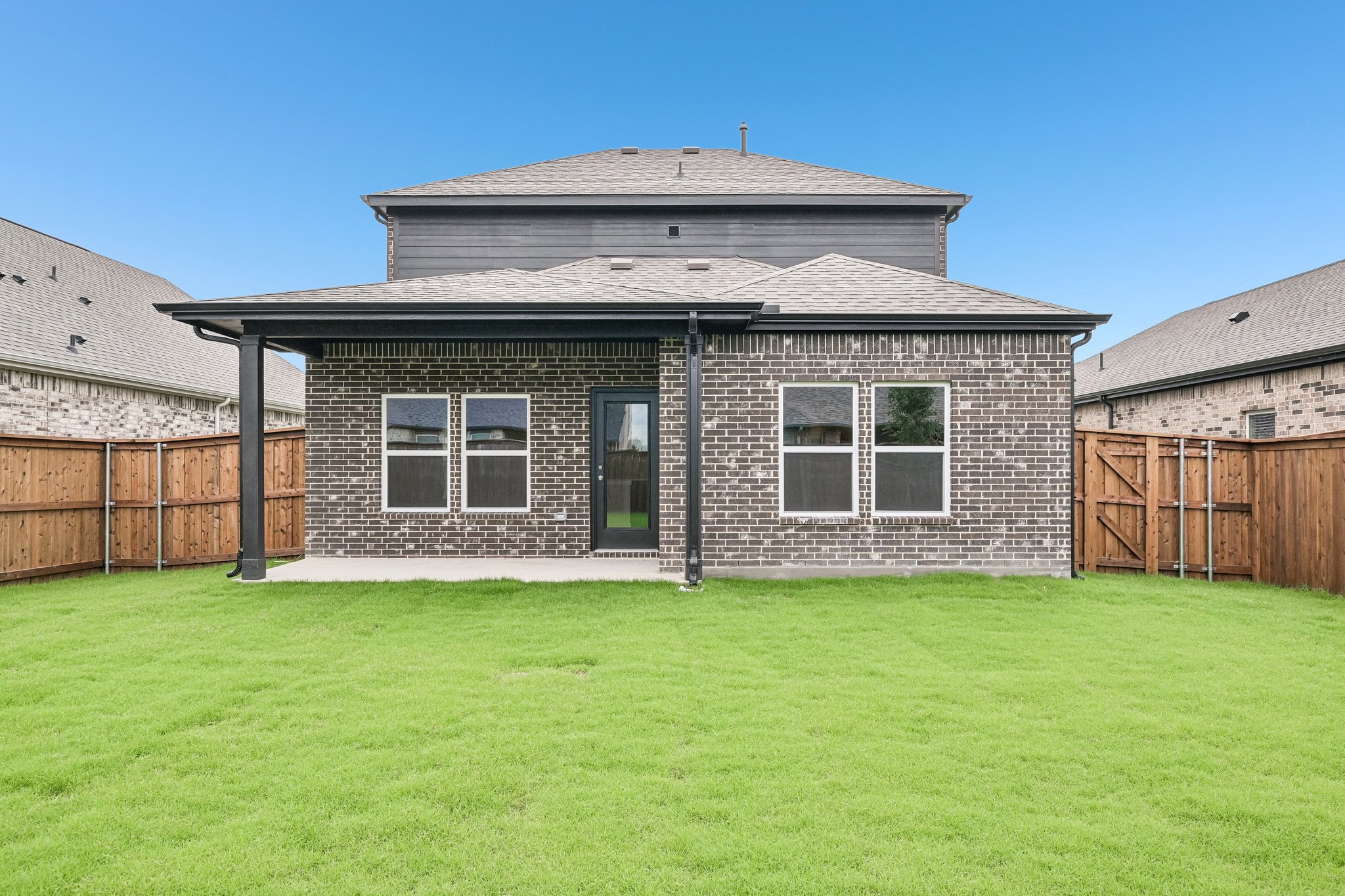 A house with a grass yard.