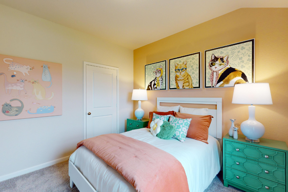 A bedroom with a bed and lamps.